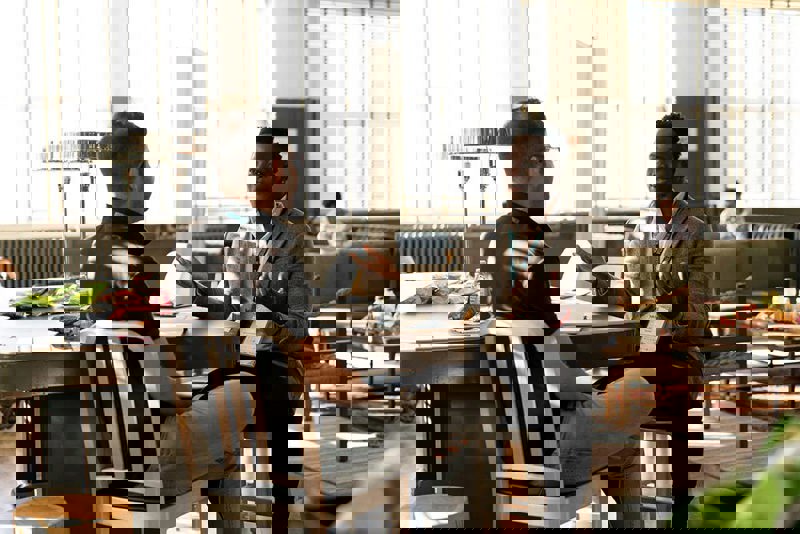 two men sitting and talking in a casual setting